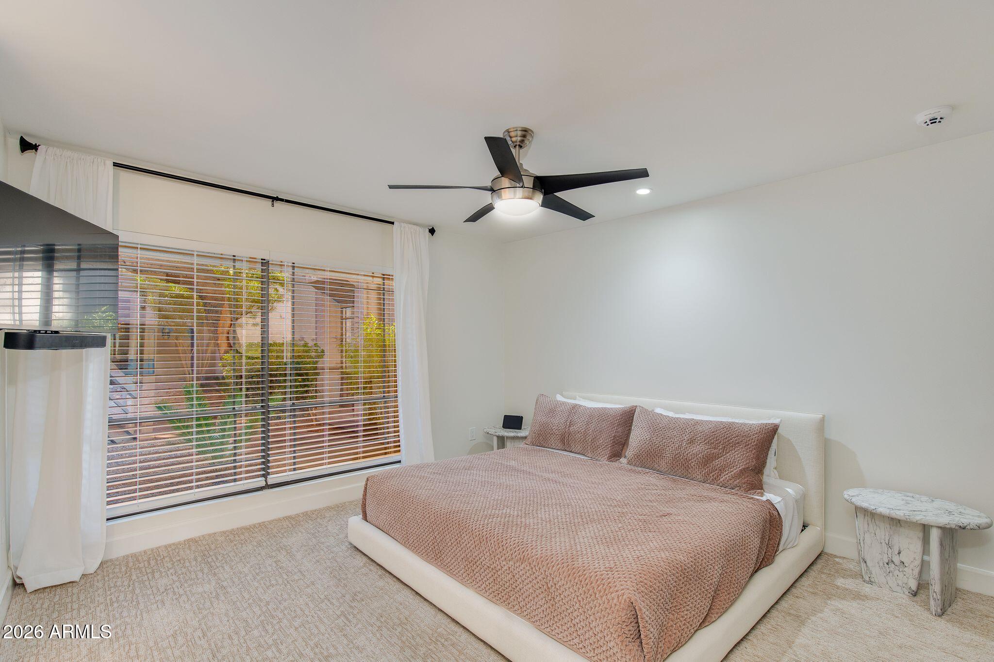 5201 North 24th Street, Unit 107 Phoenix, AZ 85016 - Photo 8 of 15 a bed room with a bed and a chair