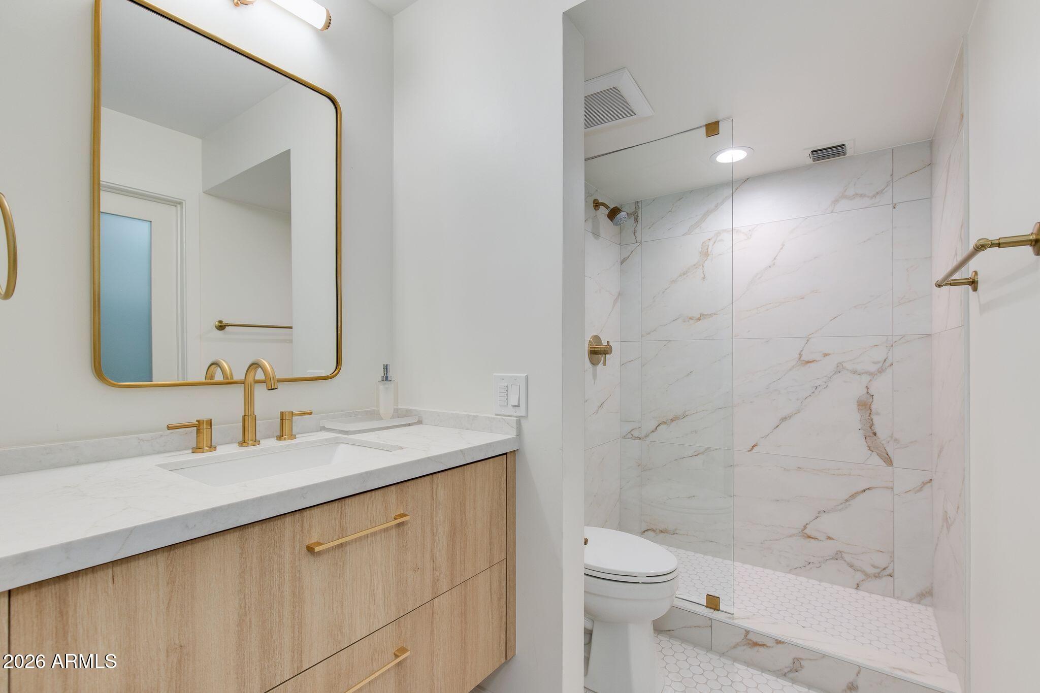 5201 North 24th Street, Unit 107 Phoenix, AZ 85016 - Photo 9 of 15 a bathroom with a sink a toilet and shower