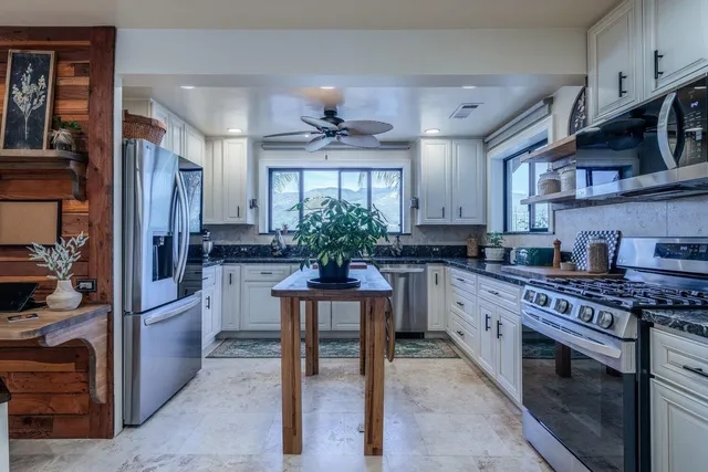 a kitchen with a refrigerator and wooden cabinets