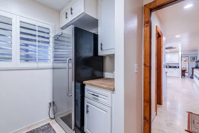 a view of washer and dryer with kitchen in the background