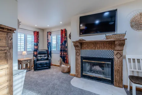 a bathroom with a granite countertop toilet sink and mirror