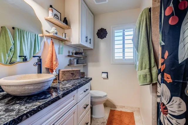 a bedroom with a bed a dresser and a window