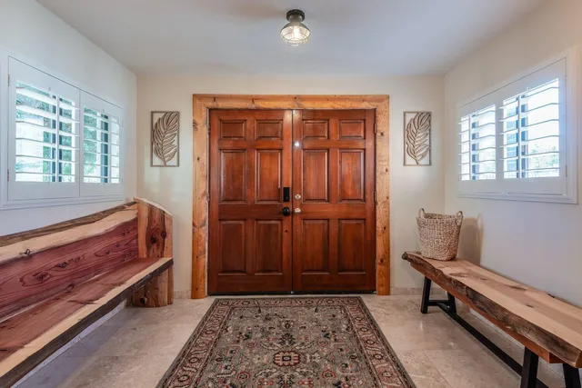 a kitchen with stainless steel appliances kitchen island granite countertop a table and chairs in it