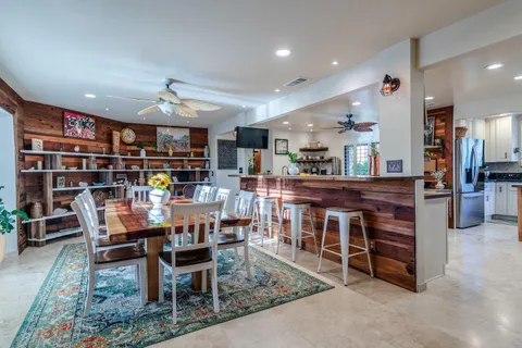 a view of a dining room with furniture and a potted plant