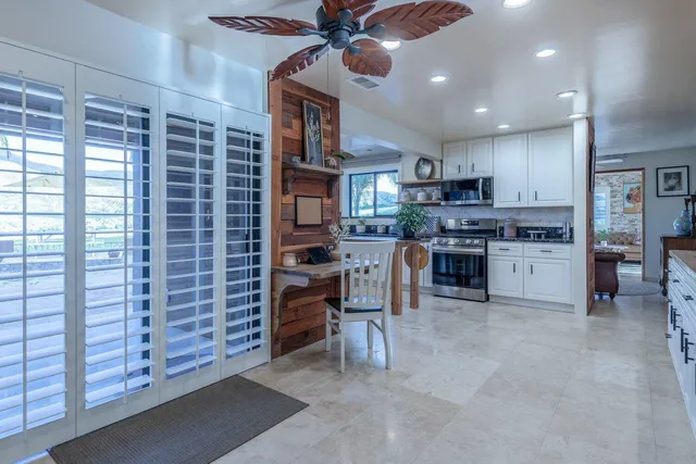 a kitchen with cabinets and window