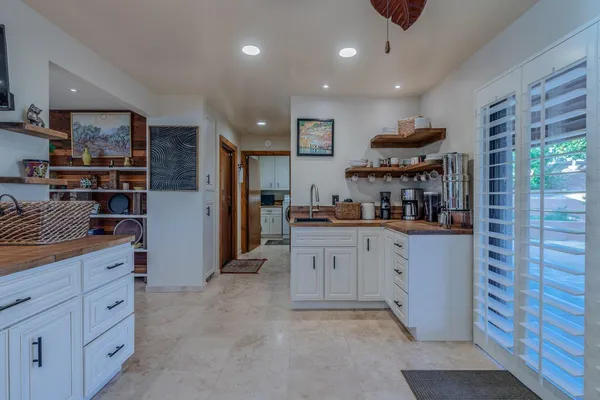 a kitchen with granite countertop white cabinets and white appliances