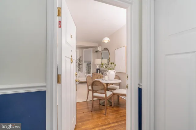 a living room with couches chairs and a chandelier