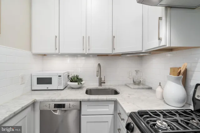 a white stove top oven sitting inside of a kitchen