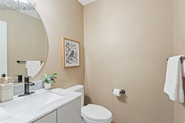 a bathroom with a sink vanity mirror and toilet
