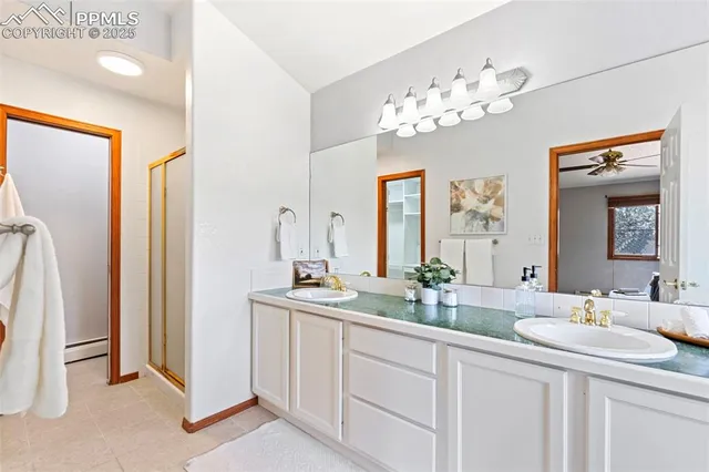 a bathroom with a double vanity sink and a mirror