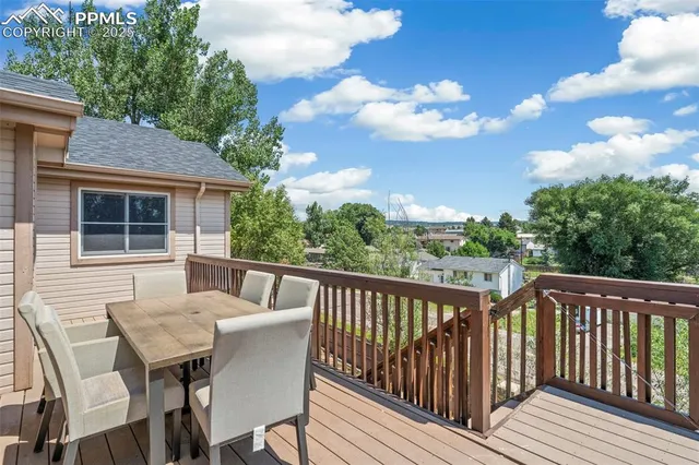 a view of a chair and table on the deck