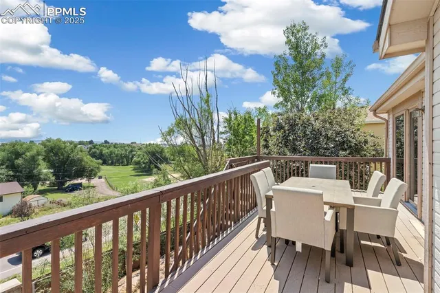 a view of a balcony with a table and chairs