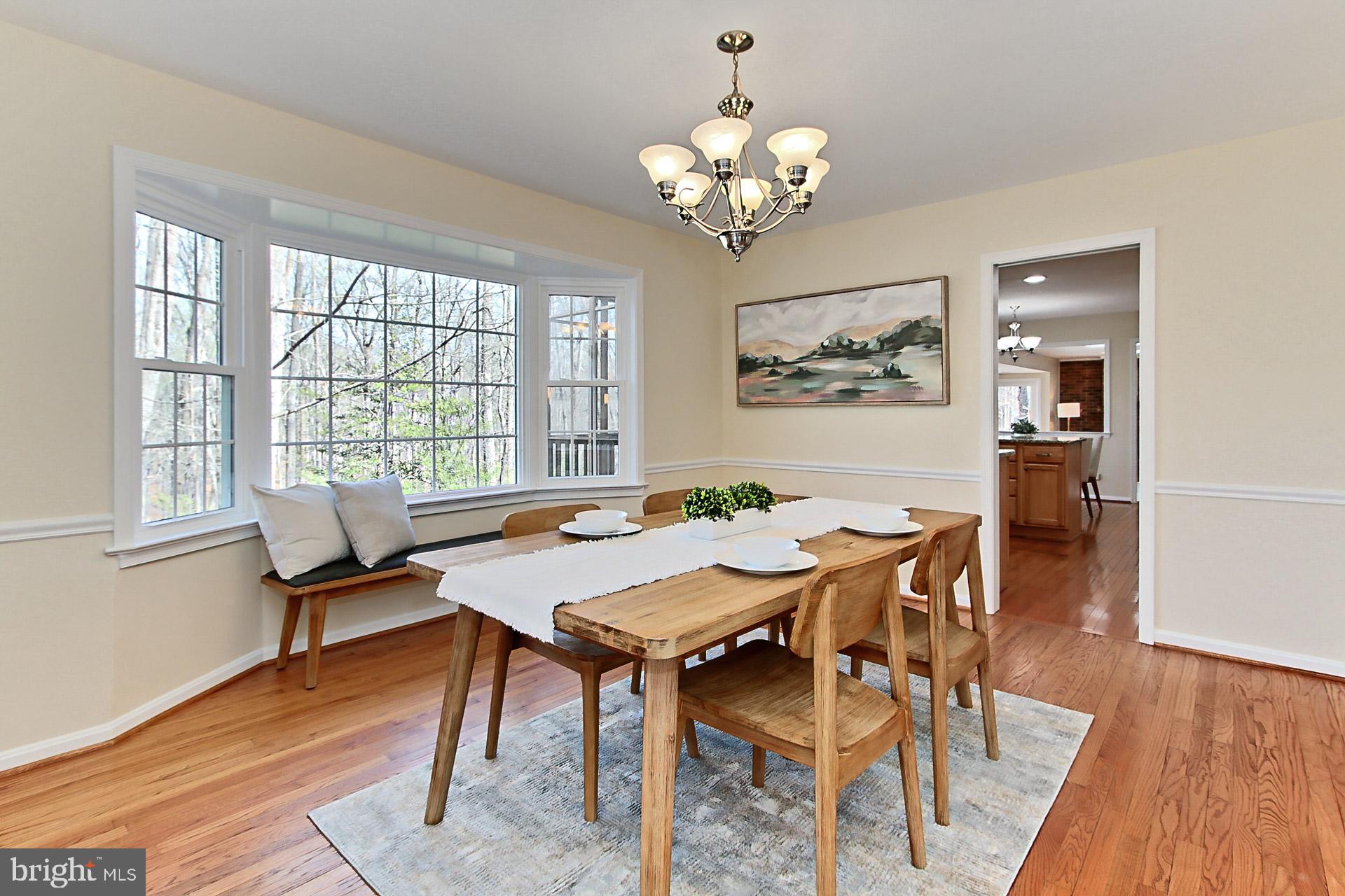 10704 Cross School Road Reston, VA 20191 - Photo 12 of 56 a view of a dining room with furniture wooden floor and a chandelier