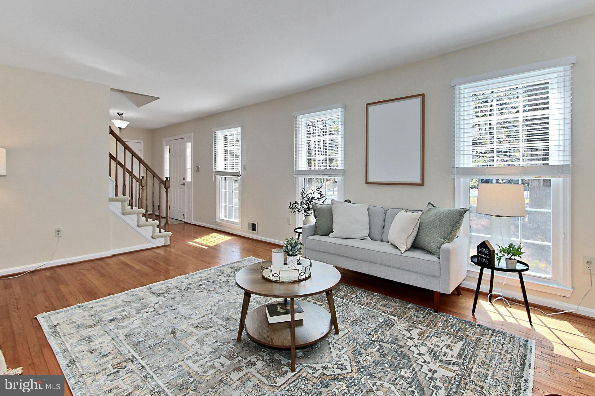 10704 Cross School Road Reston, VA 20191 - Photo 16 of 56 a living room with furniture and a dining table