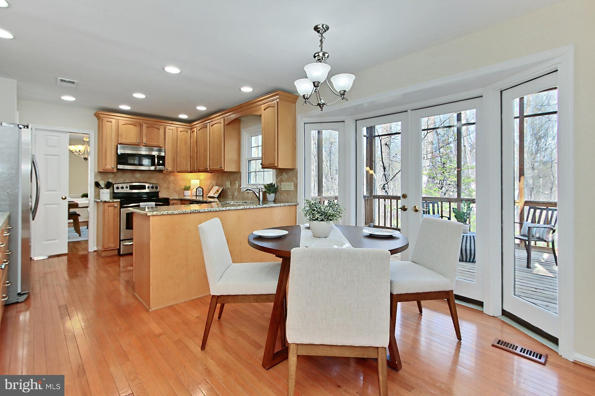 10704 Cross School Road Reston, VA 20191 - Photo 2 of 56 a view of a dining room with furniture large window and wooden floor
