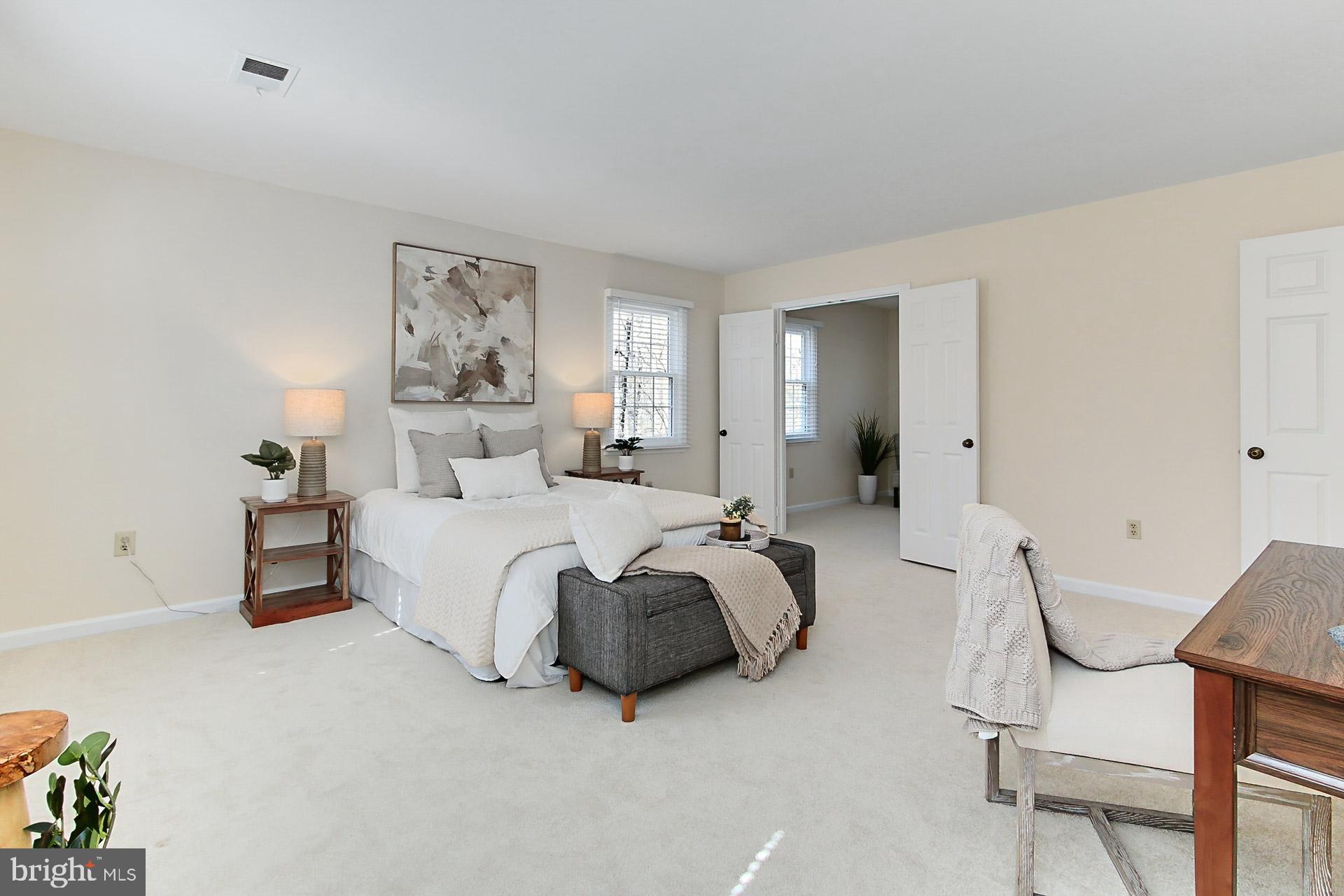 10704 Cross School Road Reston, VA 20191 - Photo 20 of 56 a spacious bedroom with a bed and a chair