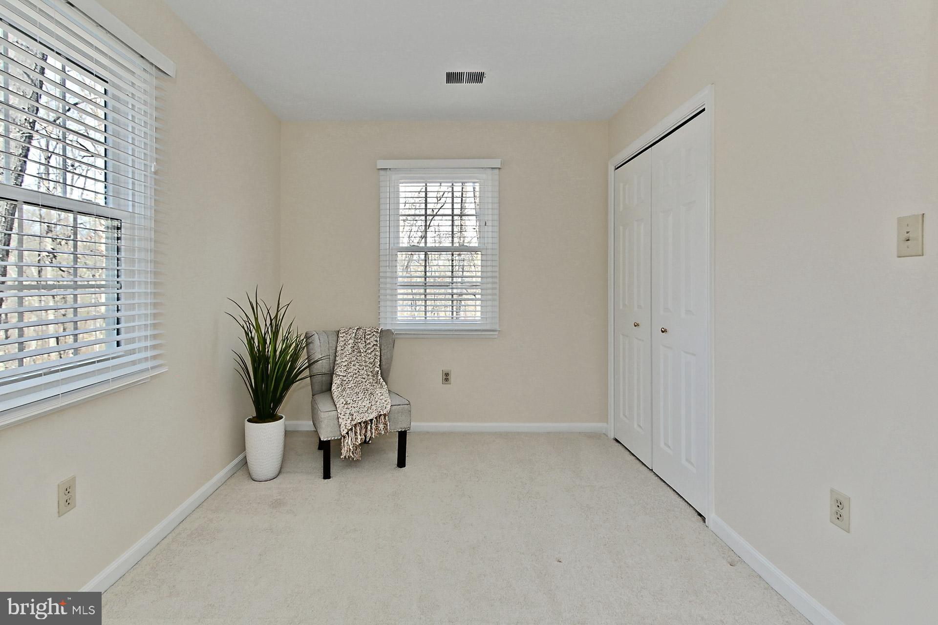 10704 Cross School Road Reston, VA 20191 - Photo 21 of 56 a view of an empty room with a window and wooden floor