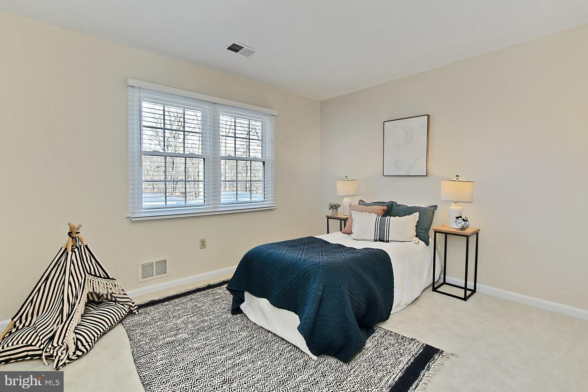 10704 Cross School Road Reston, VA 20191 - Photo 25 of 56 a bedroom with a bed and a window