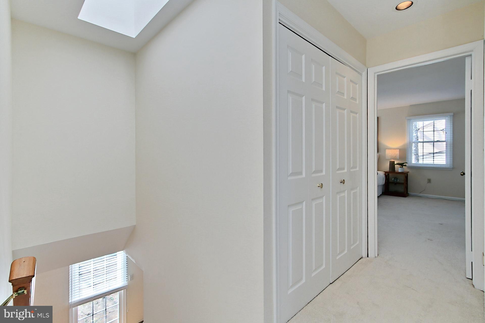 10704 Cross School Road Reston, VA 20191 - Photo 28 of 56 a view of a hallway with a livingroom and a bathroom with sink