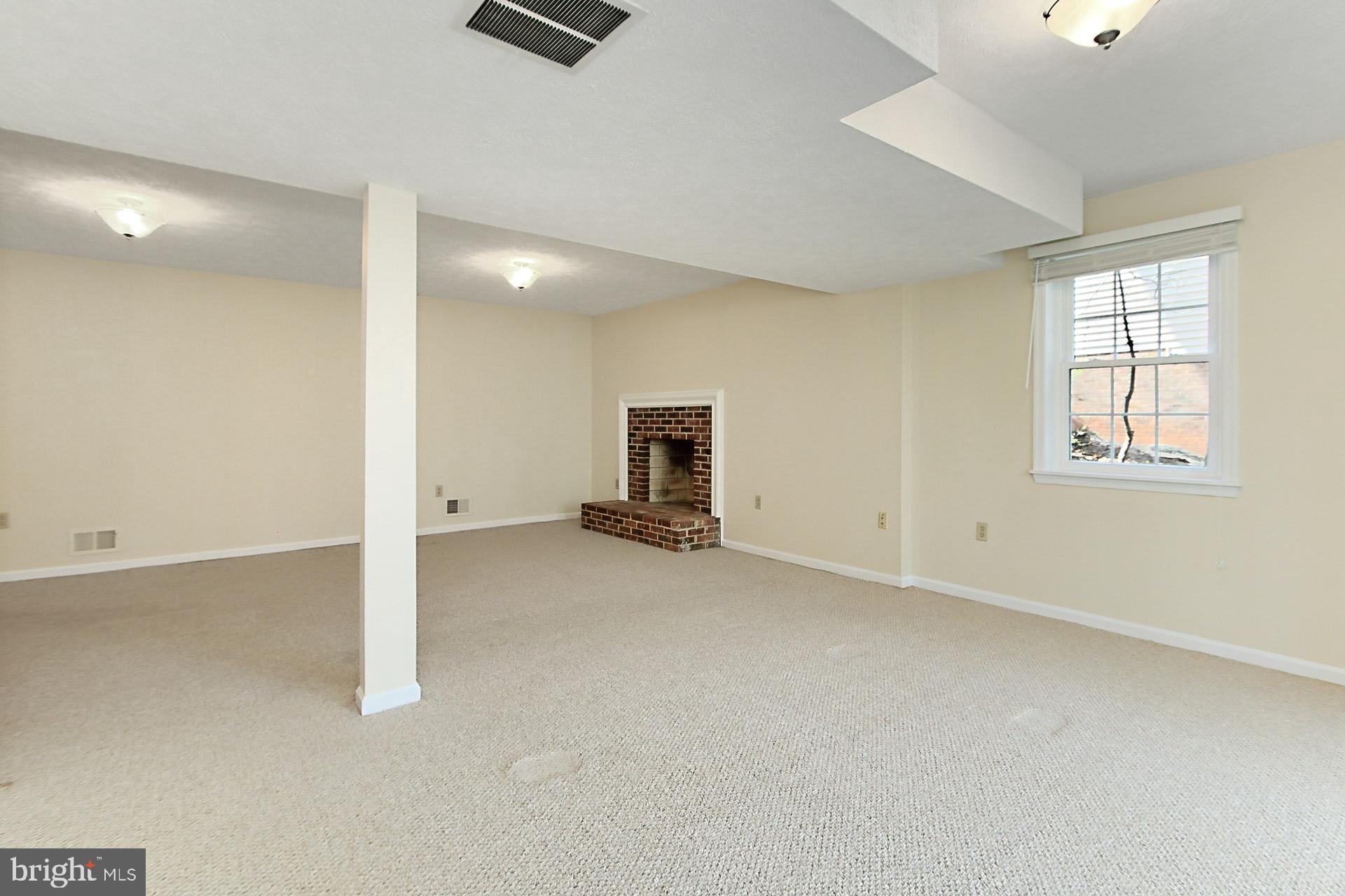 10704 Cross School Road Reston, VA 20191 - Photo 34 of 56 an empty room with a fireplace and window