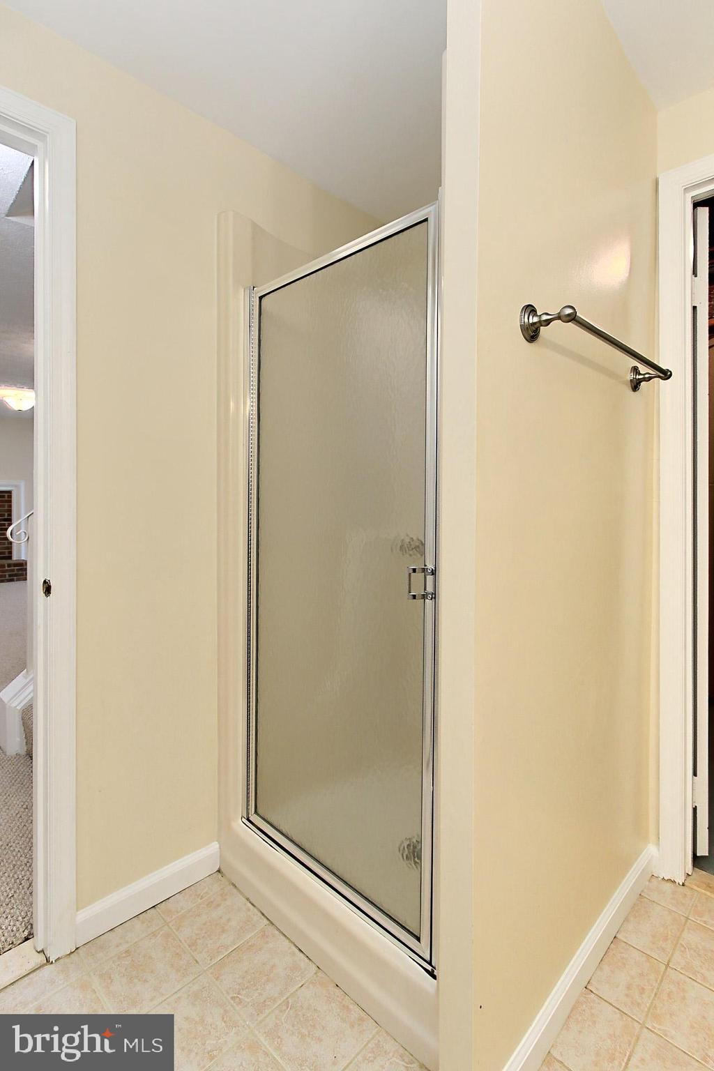 10704 Cross School Road Reston, VA 20191 - Photo 37 of 56 a bathroom with a glass shower door