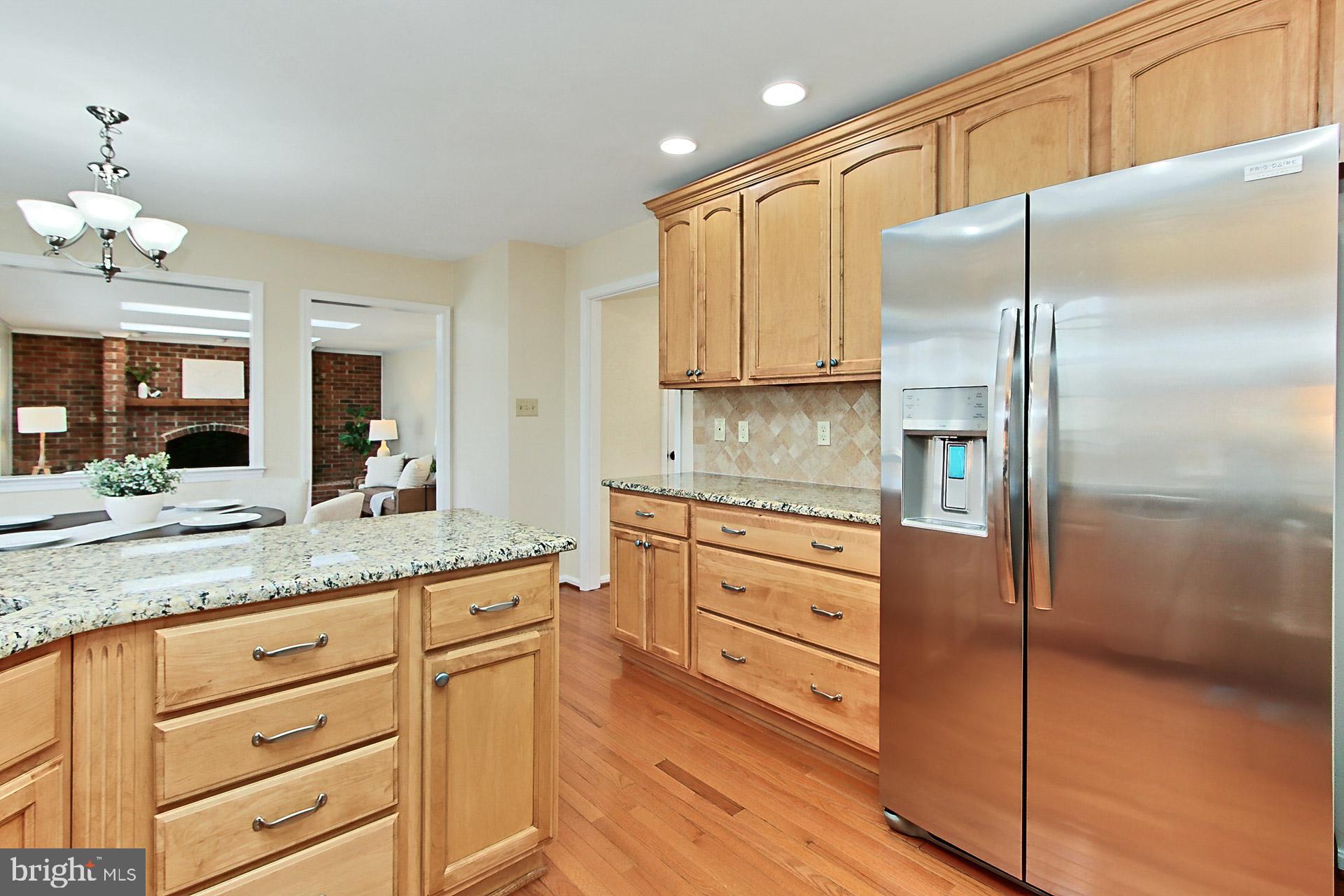 10704 Cross School Road Reston, VA 20191 - Photo 5 of 56 a kitchen with cabinets stainless steel appliances a sink and a window