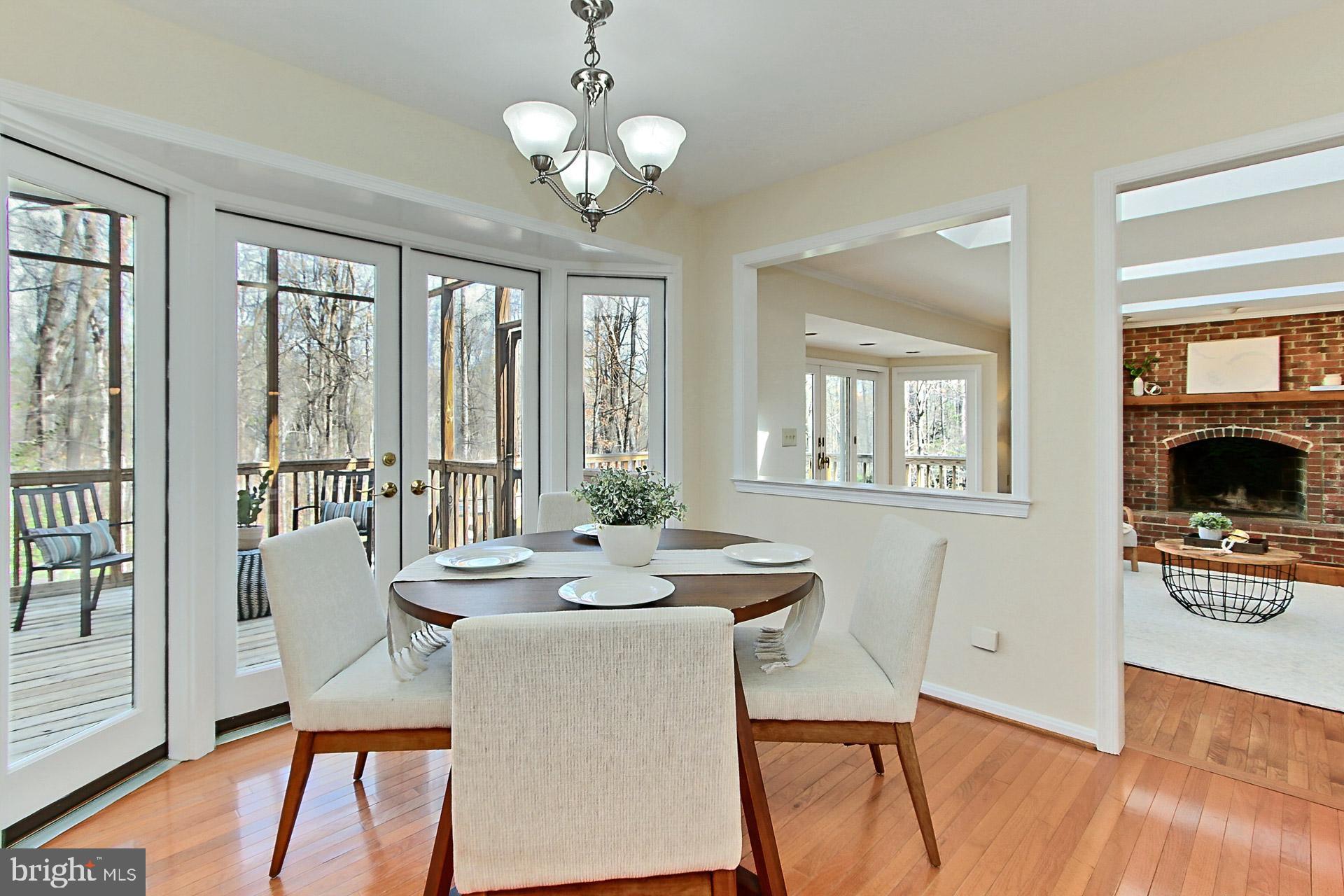 10704 Cross School Road Reston, VA 20191 - Photo 6 of 56 a view of a dining room with furniture a chandelier and wooden floor