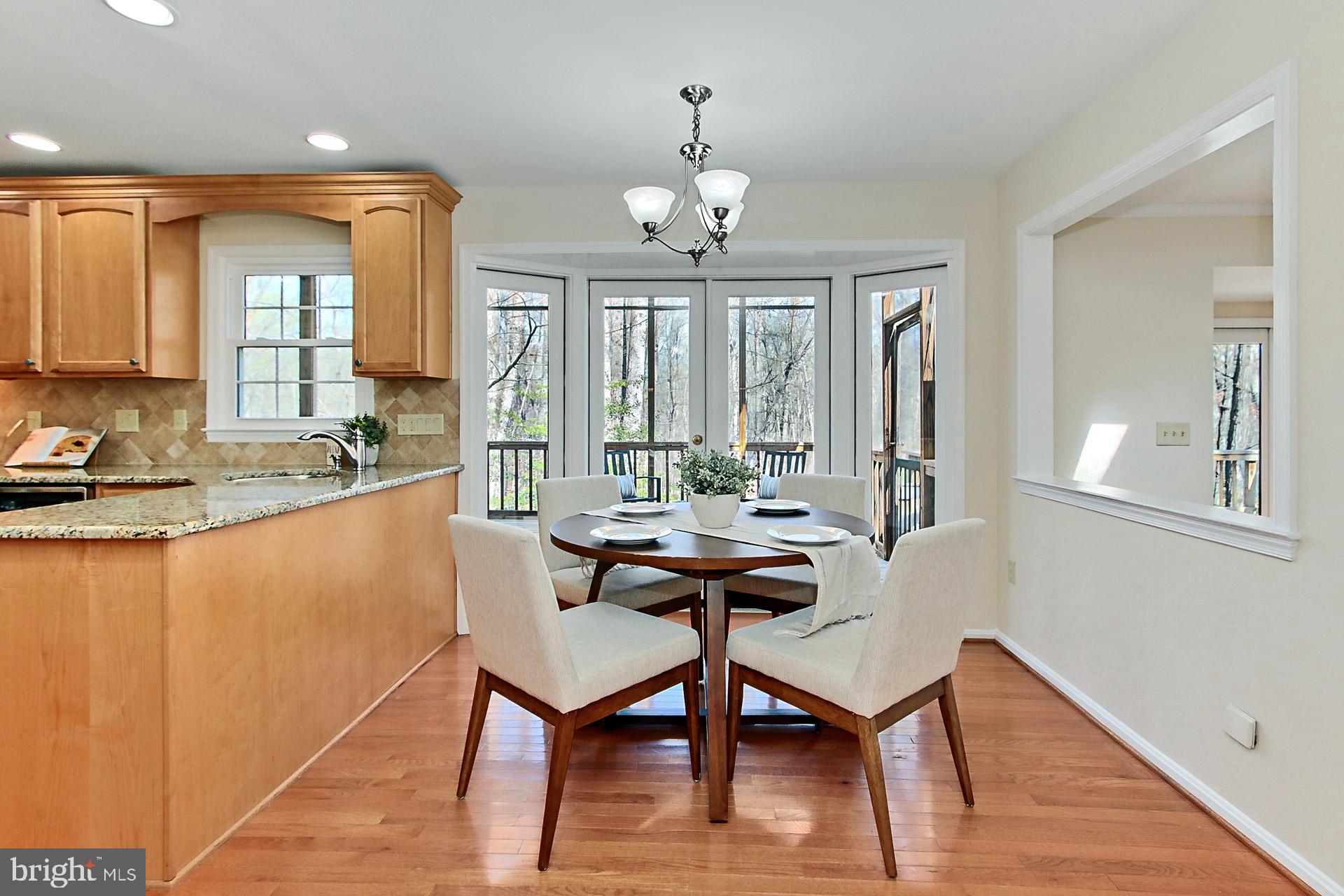 10704 Cross School Road Reston, VA 20191 - Photo 7 of 56 a view of a a dining room with furniture window and wooden floor