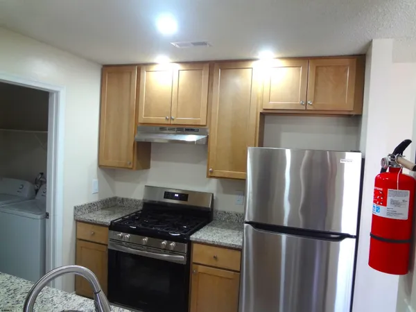 a kitchen with a stove and a refrigerator