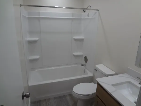 a bathroom with a toilet and a bathtub