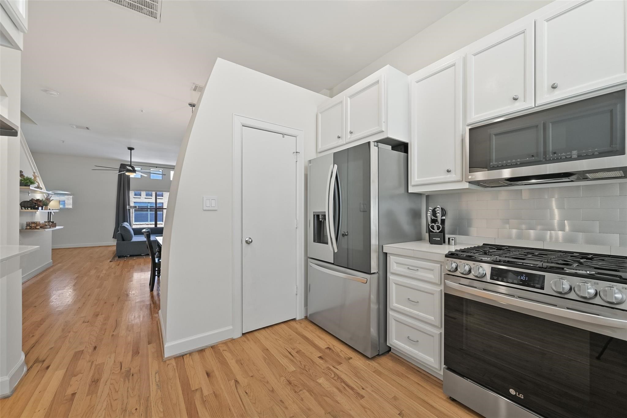 8715 Meadowcroft Drive, Unit 1002 Houston, TX 77063 - Photo 12 of 24 a kitchen with stainless steel appliances a stove a sink and a refrigerator