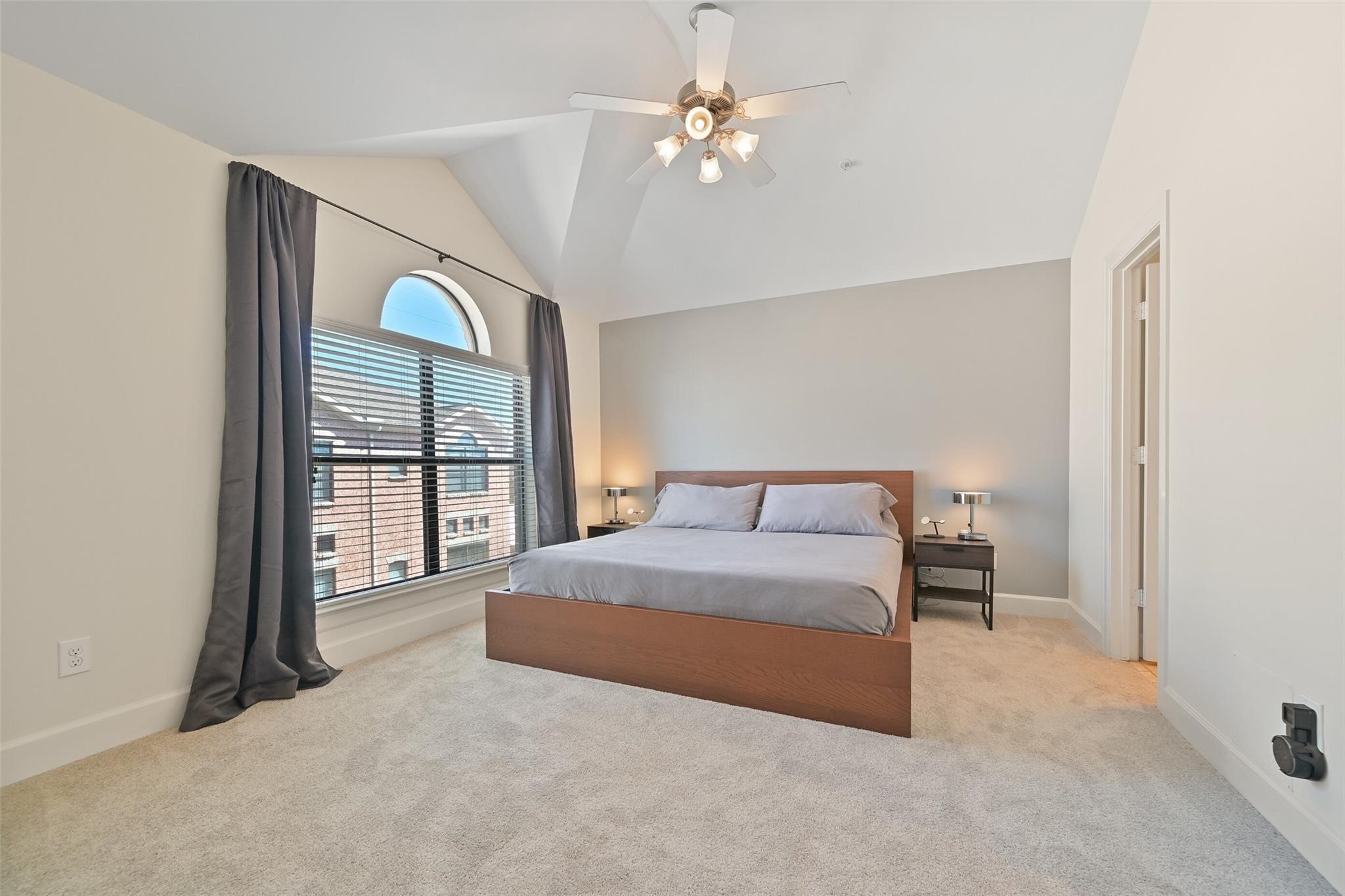 8715 Meadowcroft Drive, Unit 1002 Houston, TX 77063 - Photo 13 of 24 a spacious bedroom with a large bed and a chandelier