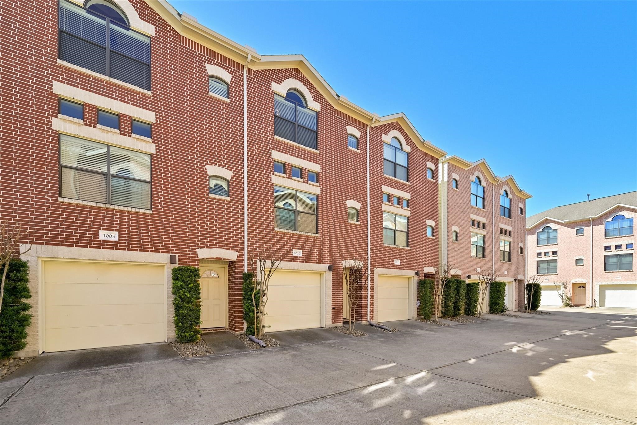 8715 Meadowcroft Drive, Unit 1002 Houston, TX 77063 - Photo 2 of 24 a front view of a building with a street