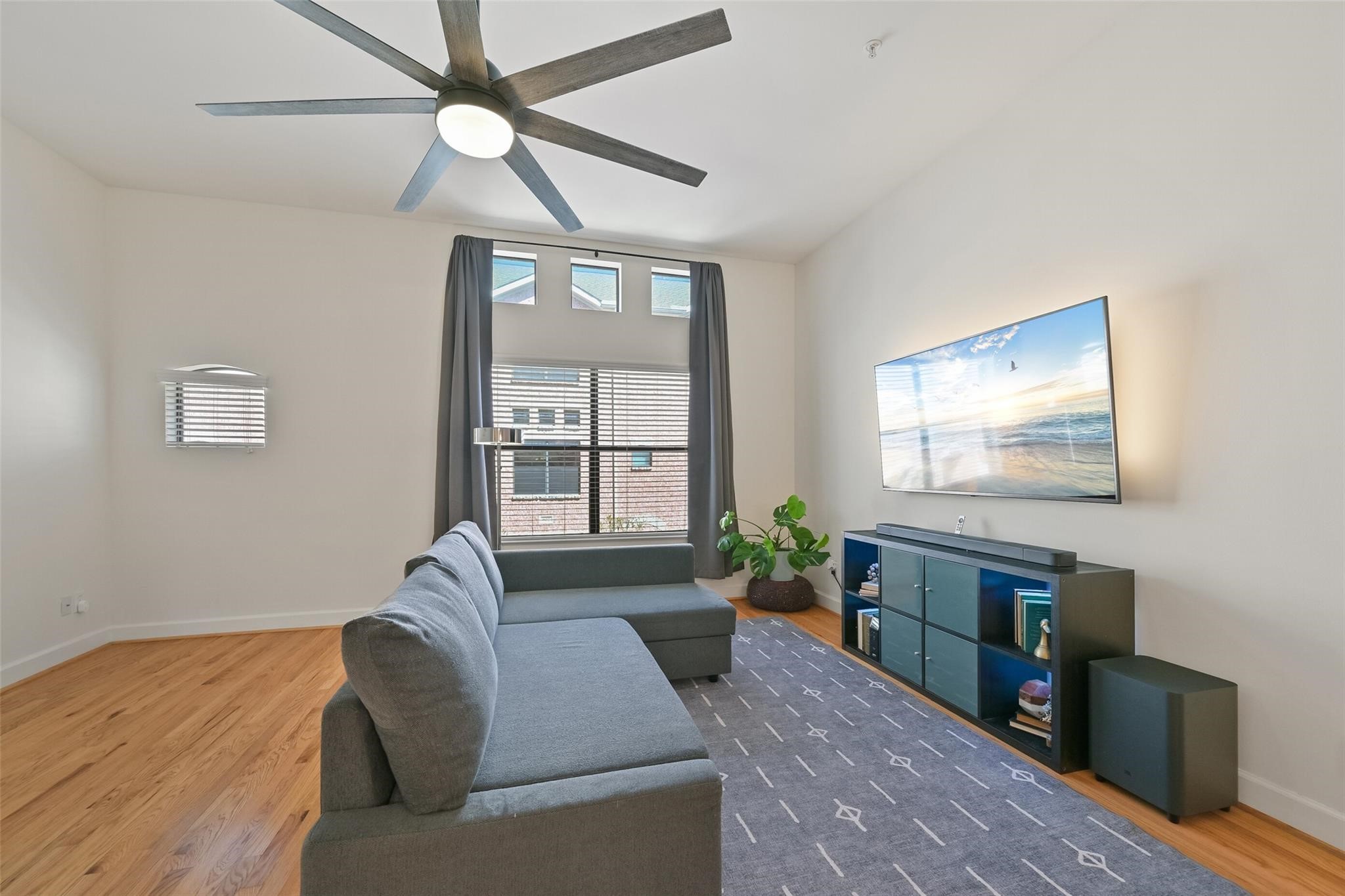 8715 Meadowcroft Drive, Unit 1002 Houston, TX 77063 - Photo 4 of 24 a living room with furniture and a flat screen tv