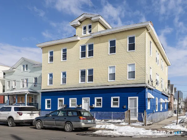 a front view of a residential apartment building with a yard