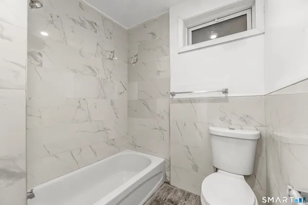 a bathroom with a toilet a sink and bathtub