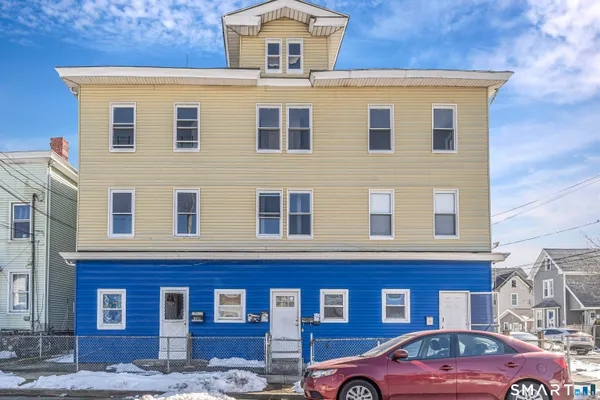a front view of a house with a parking space