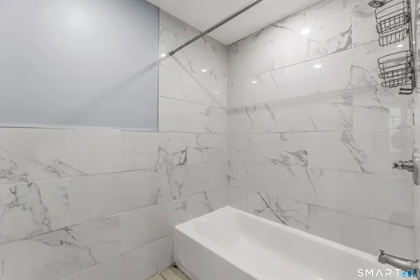 a bathroom with a bathtub and shower