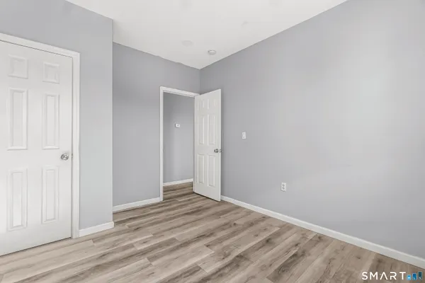 a view of a room with wooden floor