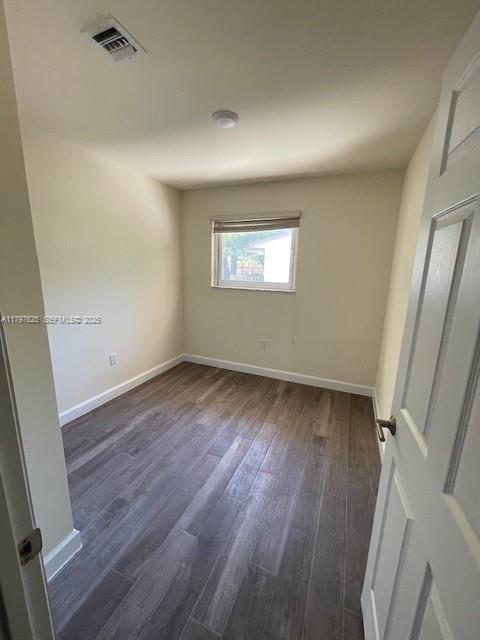 1680 Northwest 4th Avenue, Unit 8B Miami, FL 33136 - Photo 2 of 9 an empty room with wooden floor and windows