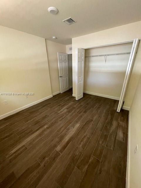 1680 Northwest 4th Avenue, Unit 8B Miami, FL 33136 - Photo 9 of 9 a view of an empty room with wooden floor and a window