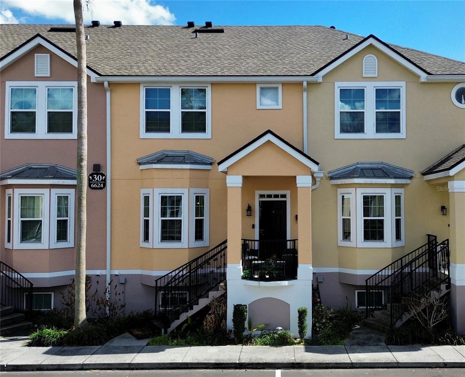 6624 Time Square Avenue, Unit 102 Orlando, FL 32835 - Photo 1 of 96 a front view of a house with a yard