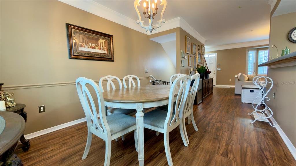 6624 Time Square Avenue, Unit 102 Orlando, FL 32835 - Photo 15 of 96 a view of a dining room with furniture and wooden floor