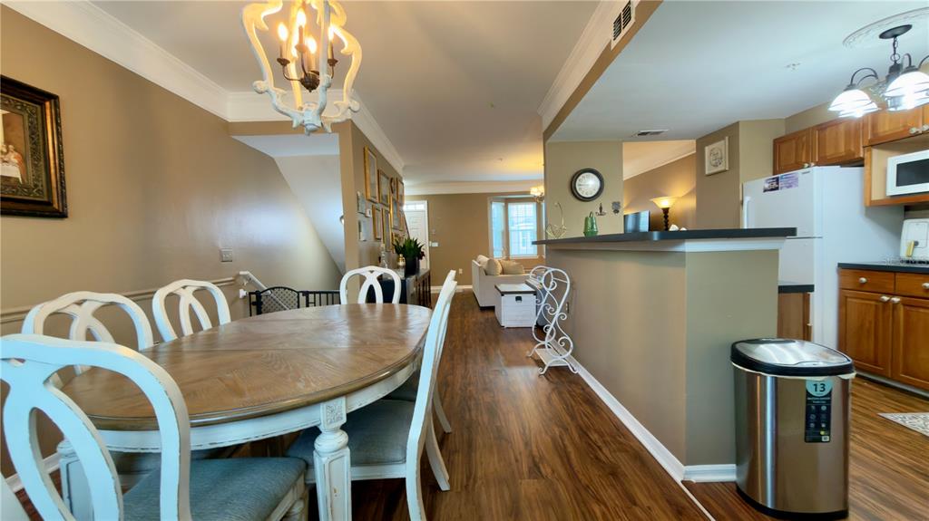 6624 Time Square Avenue, Unit 102 Orlando, FL 32835 - Photo 16 of 96 a view of a dining room with furniture and wooden floor