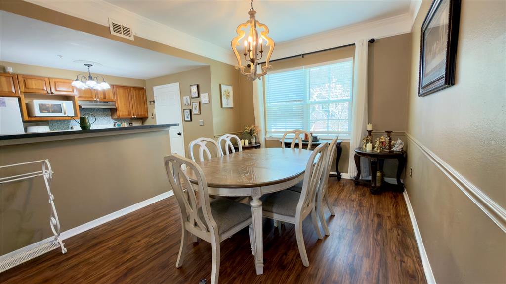 6624 Time Square Avenue, Unit 102 Orlando, FL 32835 - Photo 17 of 96 a view of a dining room with furniture window and wooden floor