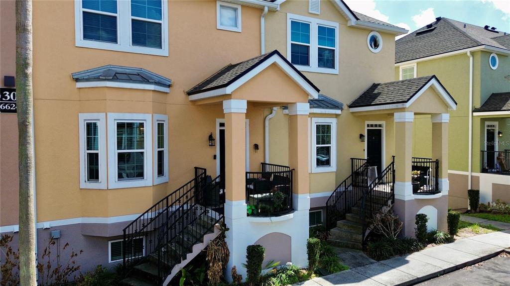 6624 Time Square Avenue, Unit 102 Orlando, FL 32835 - Photo 2 of 96 a view of a brick house with large windows and a small yard