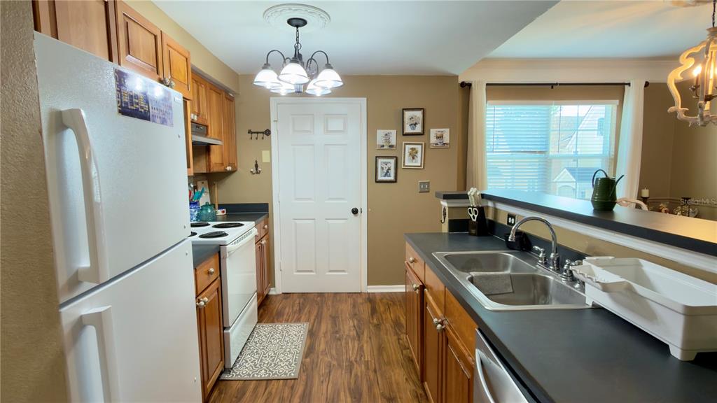 6624 Time Square Avenue, Unit 102 Orlando, FL 32835 - Photo 24 of 96 a kitchen with stainless steel appliances a sink stove and refrigerator