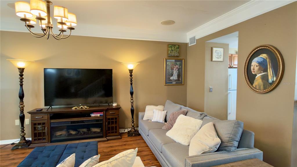 6624 Time Square Avenue, Unit 102 Orlando, FL 32835 - Photo 25 of 96 a living room with furniture and a flat screen tv