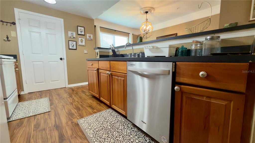6624 Time Square Avenue, Unit 102 Orlando, FL 32835 - Photo 32 of 96 a kitchen with stainless steel appliances granite countertop a refrigerator and a sink