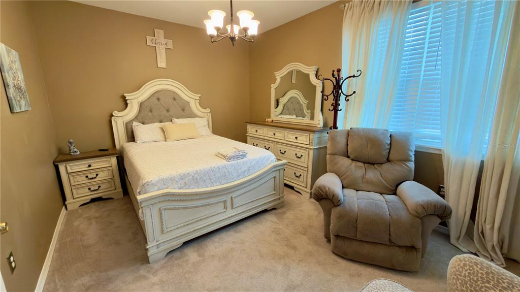 6624 Time Square Avenue, Unit 102 Orlando, FL 32835 - Photo 51 of 96 a bedroom with a bed couch and window